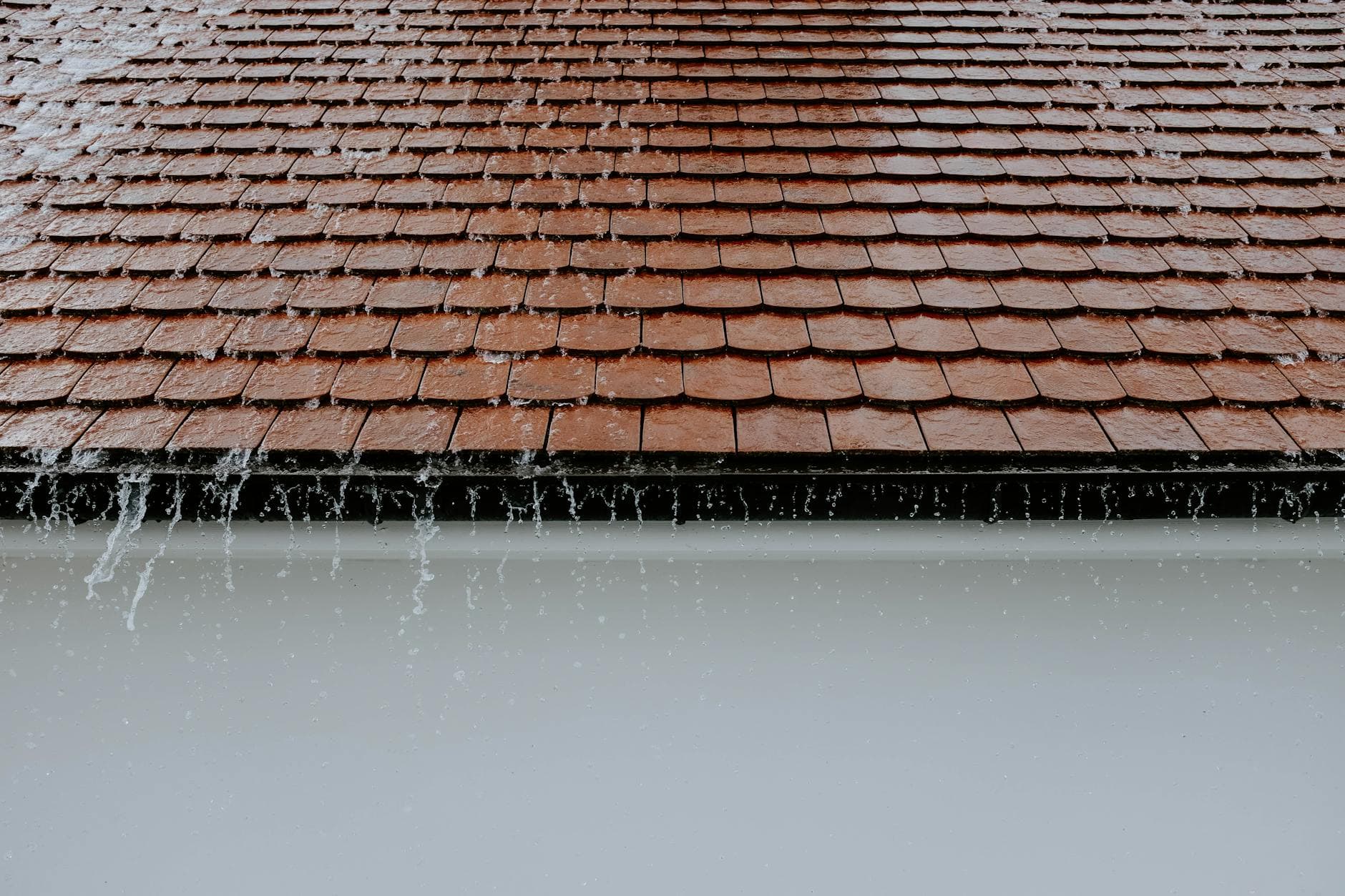 Rainwater cascading down roof tiles